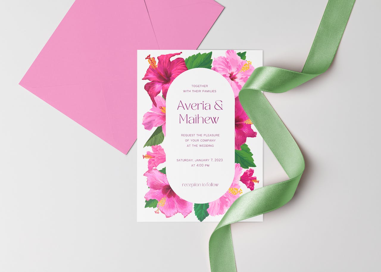Elegant wedding invitation with floral design and pink envelopes, perfect for special celebrations.